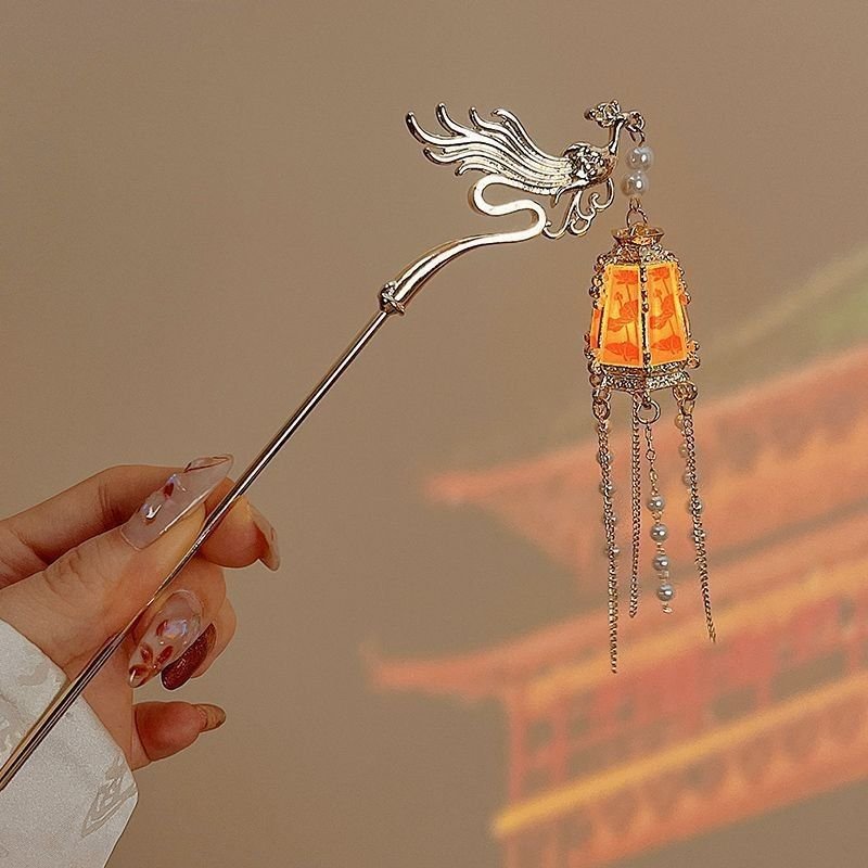 Blue celestial hairpin with phoenix charm, embodying harmony and light.