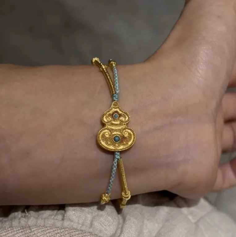 Close-up of Harmony Halo Lucky Charm Bracelet with mystic gourd charm.