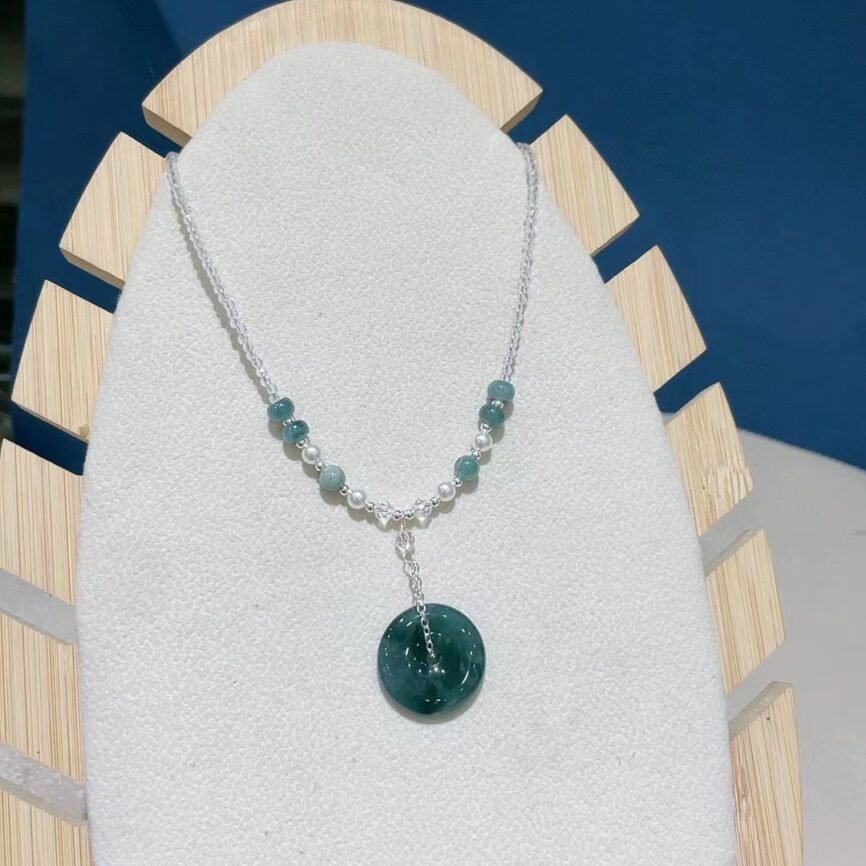 Blue jade necklace with Moonlock charm for serenity and safety.