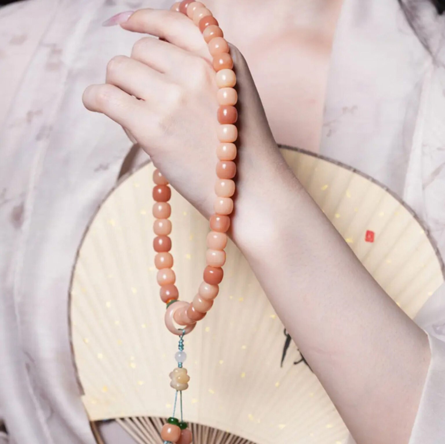 Eternal Bliss Peachwood Mala with charm, artisan jewelry for wealth and harmony.