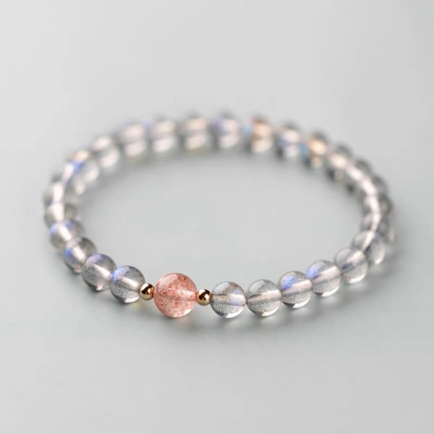 Onyx bangle bracelet with yin-yang charm, channeling lunar energy.