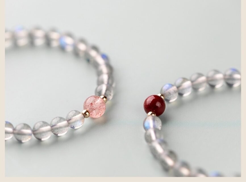 Onyx bangle bracelet with yin-yang charm, channeling lunar energy.