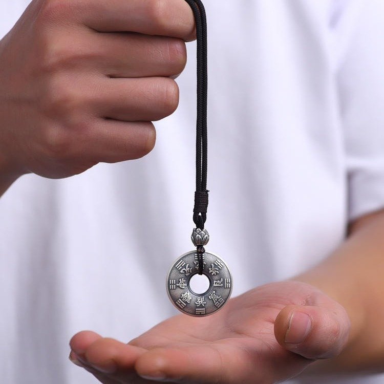 Celestial metal pendant with ancient Chinese guardian charm, artisan jewelry.