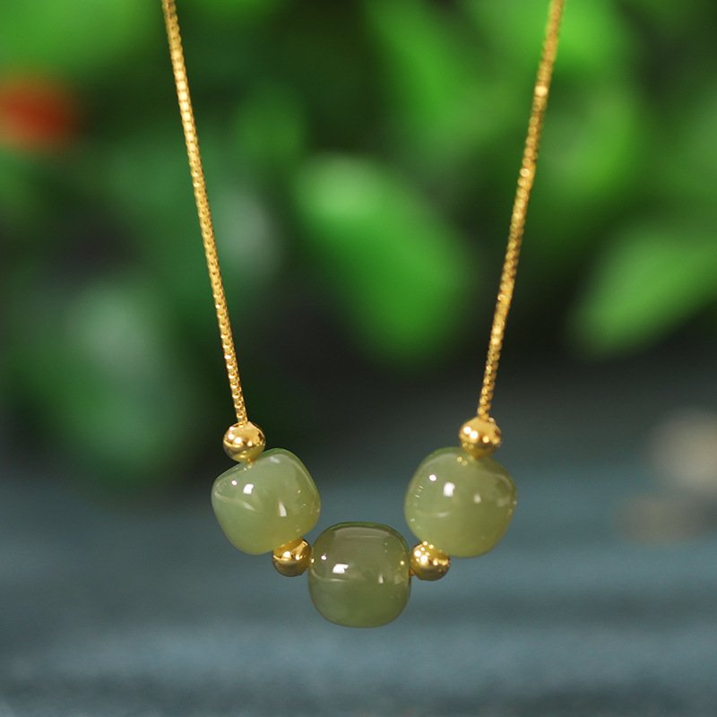 Blue celestial radiance necklace with emerald charm, artisan jewelry.