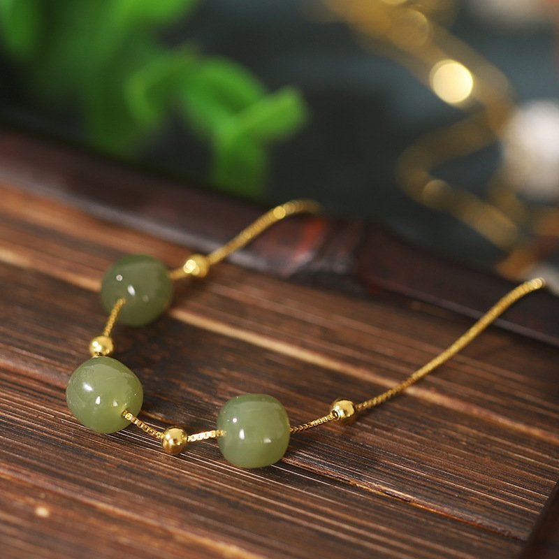 Blue celestial radiance necklace with emerald charm, artisan jewelry.