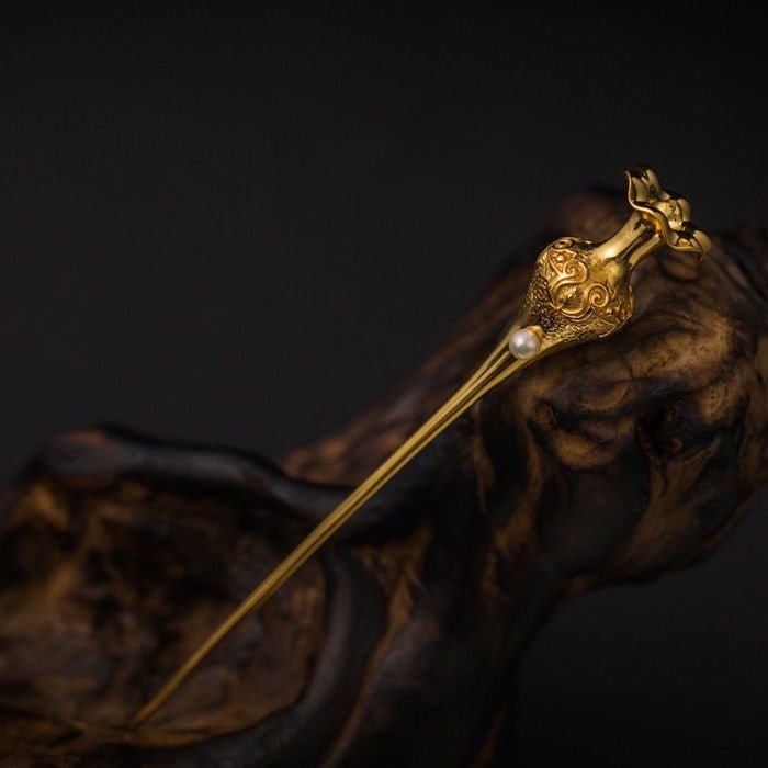 Golden blooms artisan hairpin with cloud pendant light charm, close-up view.